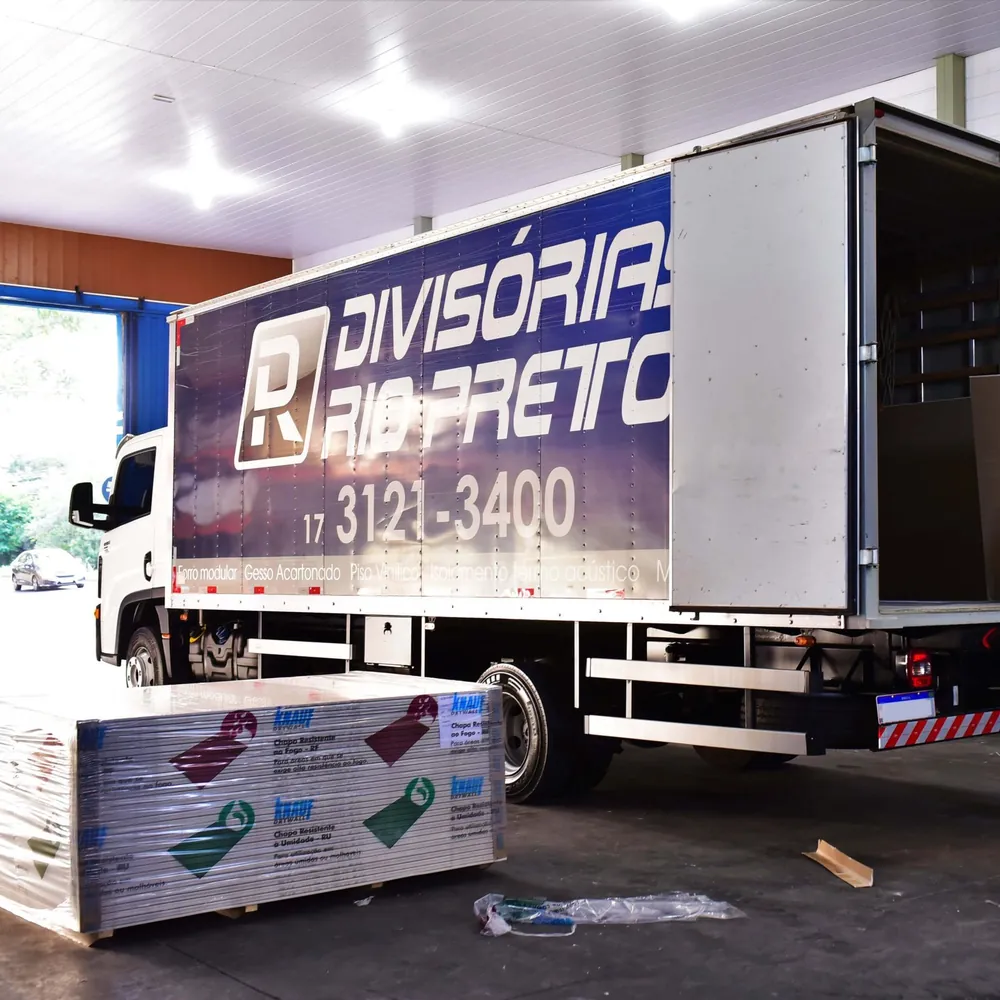 Caminhão da Divisórias Rio Preto carregando chapas de drywall Knauf dentro do galpão da empresa